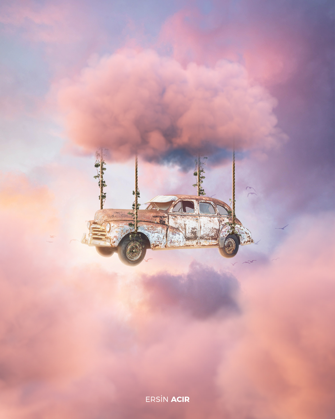 Picture of pale pink clouds, flying vintage car