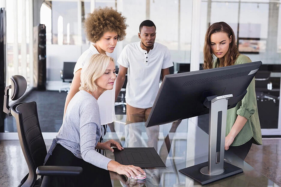 Team collaborating using a ViewSonic ergonomic monitor.