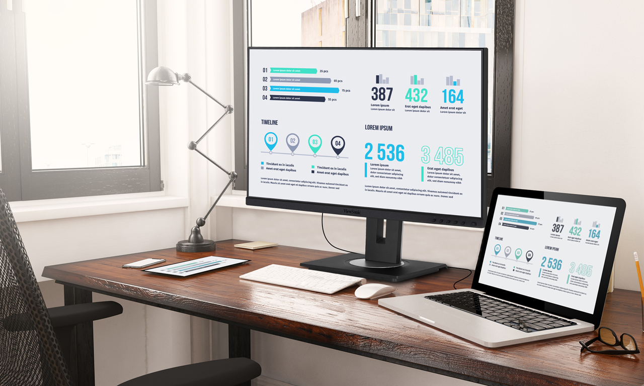 Employees viewing company updates on a big screen.