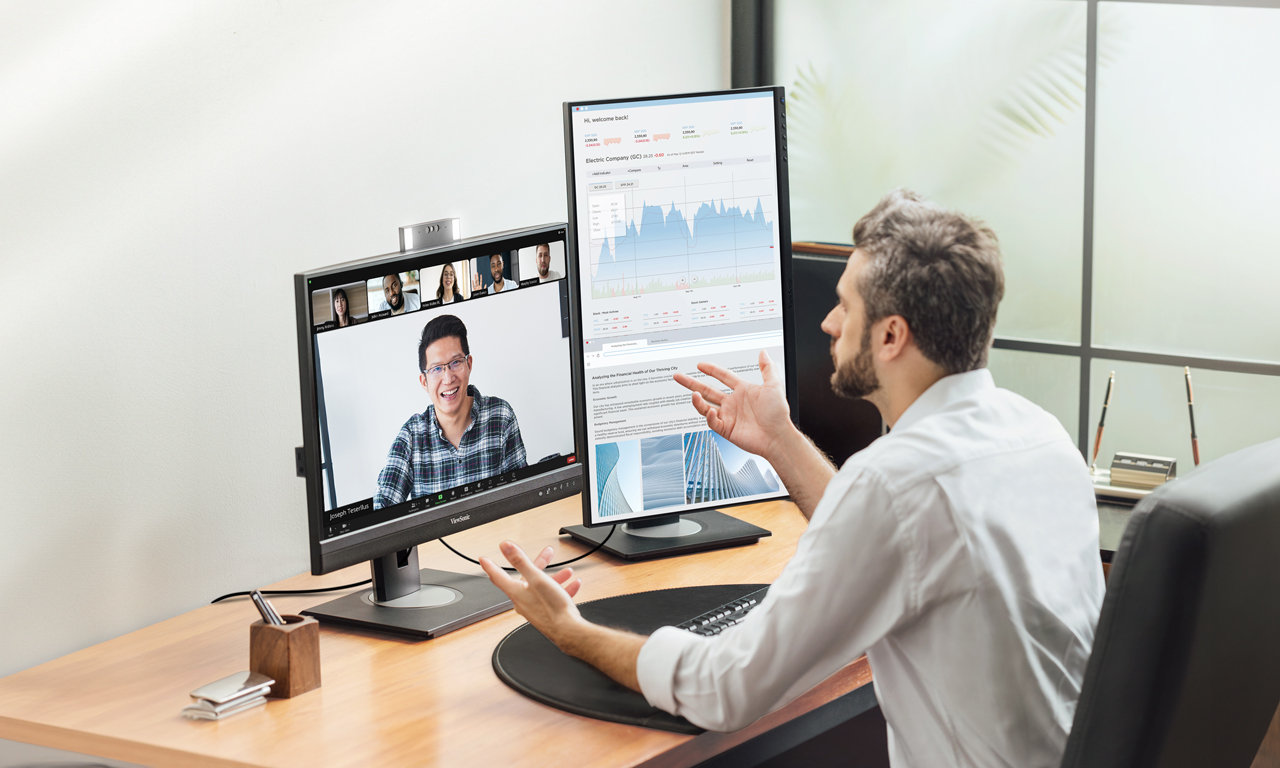 Large ultra-wide display showcasing data visualization in a workspace.