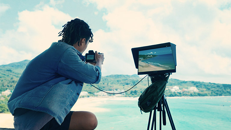 Creator previewing shots outdoors.